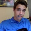 cute guy is playing his guitar in a blue polo a