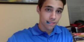 cute guy is playing his guitar in a blue polo a