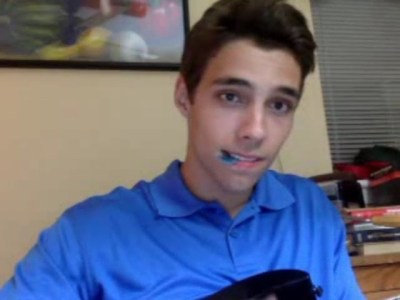 cute guy is playing his guitar in a blue polo a